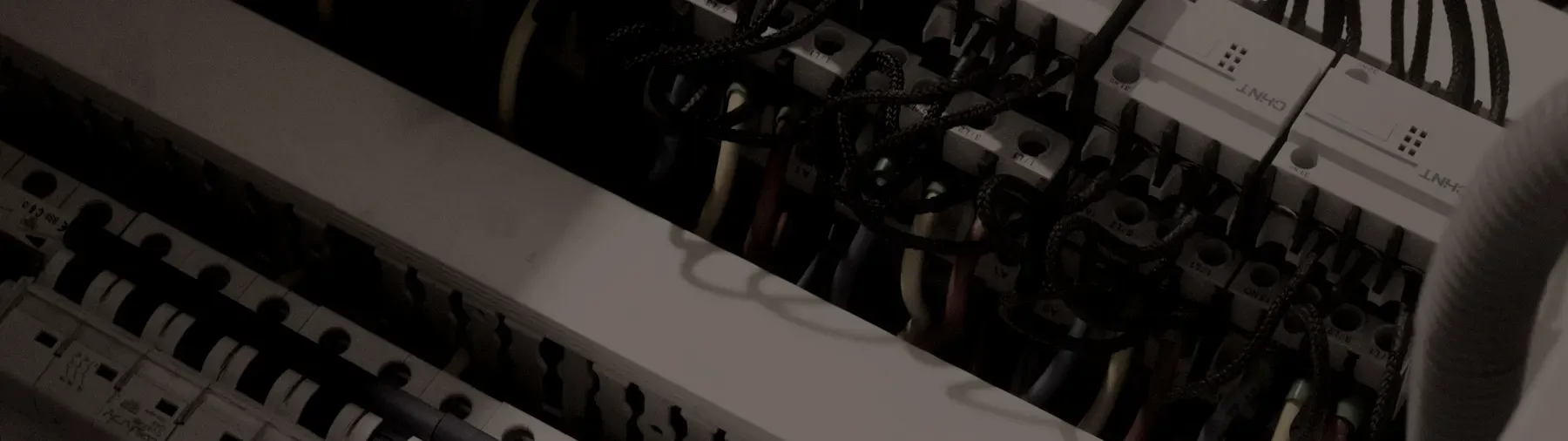 The inside of a switchboard, circuit breakers and looped wiring